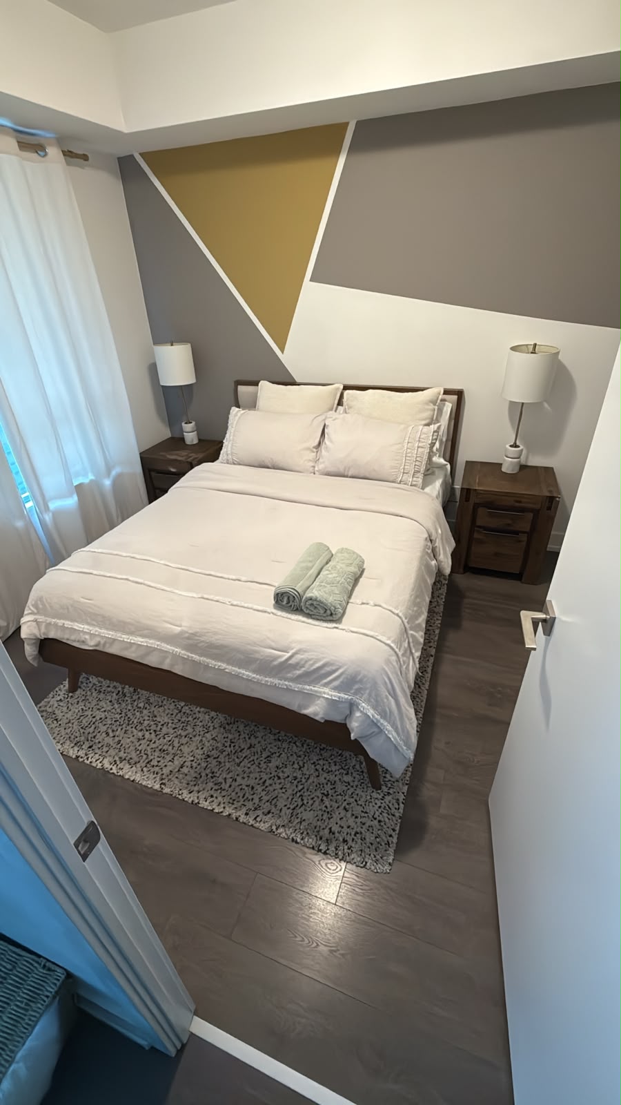 Airbnb bedroom with fresh linens and folded towels