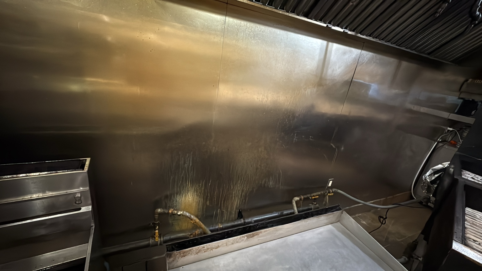 Commercial kitchen wall during a deep degreasing service